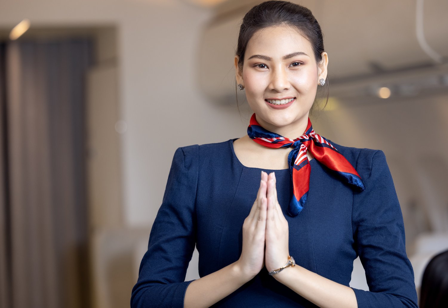 Cabin crew or Stewardess greeting passengers on airplane, Air hostess or stewardess service